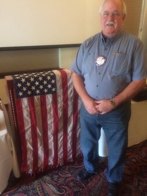 STEAMING FLAG - Mike Chandler with the steaming flag of the USS Ronald Reagan's 2008 Persian Gulf tour; a gift from Kevin 'Bud' Couch who was the XO on that tour.